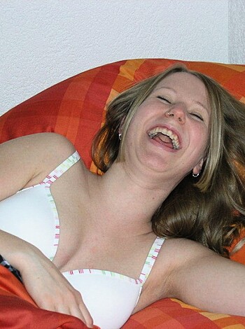 "A busty broad lying on her back, wearing a bra."