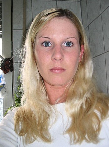 "Blonde bimbo takes a selfie while getting her tits out."