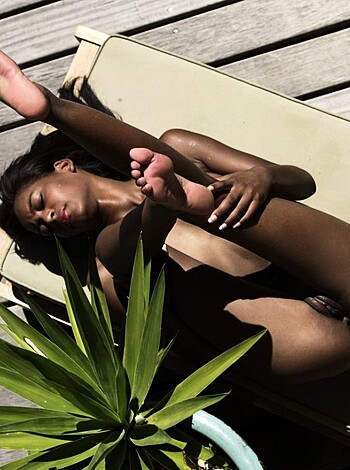 Here's the fucking photo of some asshole lying on a wood planks with his ass up in the air while he's spreading those fucking legs like a slutty bitch, and some dumbass plant is sitting next to this dickhead.