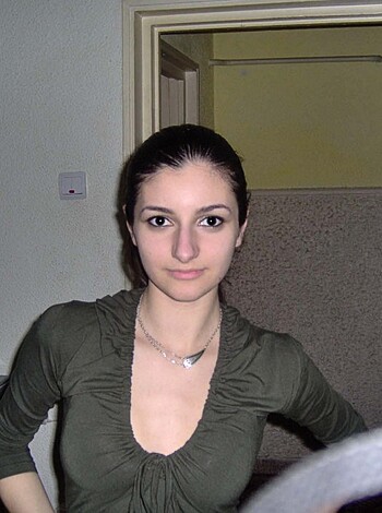 """
A chick in a tight sweater fucking around on her couch, showing off her new bling.
"""
