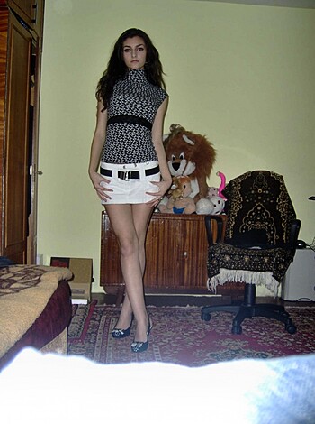 Here's the fuckin' description of the fuckin' image: A hot slutty chick, dressed in lingerie, bends over with her ass sticking out while she poses in some guy's house.
