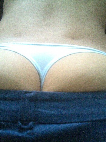 "Check out this fucking hot ass shot of some chick with her panties peeping out from under her shirt. Her back and butt look so fucking smooth, it's making my dick hard just looking at it."
