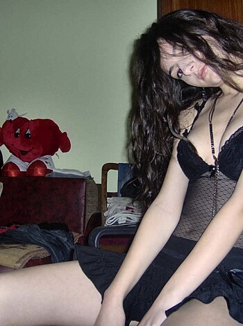 "Check out this fucking hot babe in her panties, sitting on some chair in what looks like someone's bedroom."