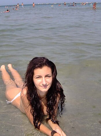 Damn sexy bitch lying on hot sandy shore in some skimpy swimwear with tits and ass out for all to see, enjoying the sun and her own fucking radiance.