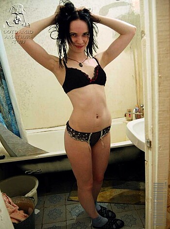 A half-naked chick is taking a shit with her ass hanging out of the stall while she's sporting a bra and thong underwear, revealing her milky white skin and curvy figure.