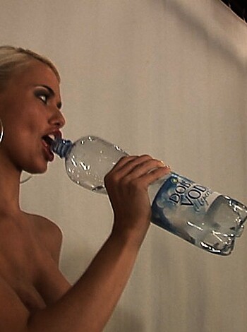 Vulgar description:
Look at this fucking hot bitch with her tits hanging out, taking a goddamn sip of water like a total slut.
