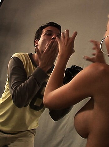 """
Brunette dude with a camera watches as his blonde model sheds her lingerie.
"""