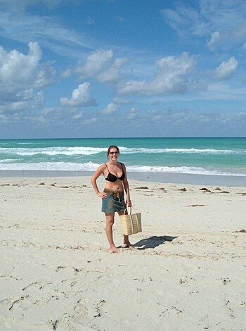 A hot blonde babe with huge tits is standing in her tight pink bikini on the fucking sandy beach, showing off her sexy legs and ass while she looks at the camera and smiles, ready to get laid by any dude who can handle this piece of meat.