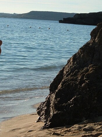 "Fucking hot babe struts her shit on the sand, sipping from a cocktail glass while sporting a tight-assed two-piece."