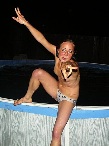 A topless chick taking a selfie at night while flashing her tits and ass.
