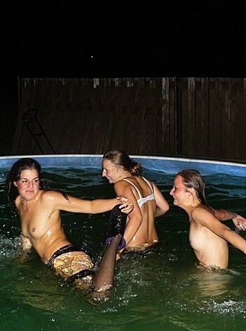 Three bitches taking a dip in the pissy water under the starry sky, trying to look hot.