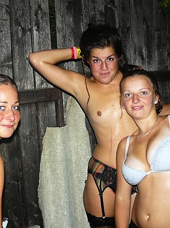 Three sluts flashin' their tits while takin' a picture in the dark.