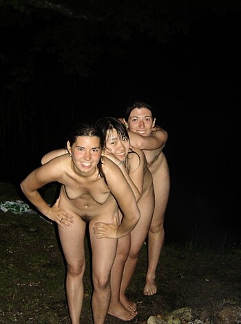 A group of three completely nude individuals standing side by side, showing off their genitalia and private parts.