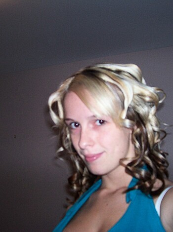 """
A bitch with pink plastic shit-catchers on her skull is staring directly into the camera, looking like an asshole with a bad dye job and no makeup. Her fucking stupid hairdo can't even hold a curl for more than five seconds before they all turn into a limp, lifeless mess that looks like shit on her head.
"""