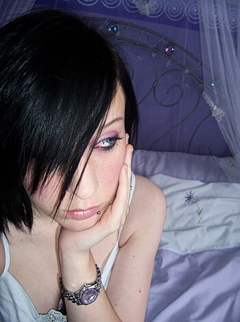 "Check out this chick sittin' on a bed covered in purple fuckin' wallpaper with some goddamn canopy shit draped over it all while she's got on a tight as fuck white t-shirt, bro. Just look at her hot ass."