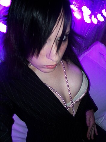 "A sexy babe flashes her tits for the camera while rocking a tight black jacket."