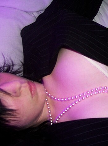 """
Naked broad with matching panties and necklace laid out on her back on mattress, taking a break from banging.
"""