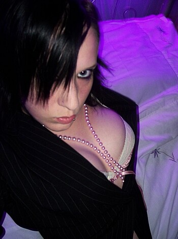 A busty blonde in panties and a fucking choker poses for the camera.