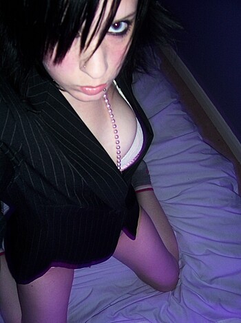 Here's a shot of some chick, lying naked with her ass up on the bed, wearing a fuckin' necklace and a goddamn bra.