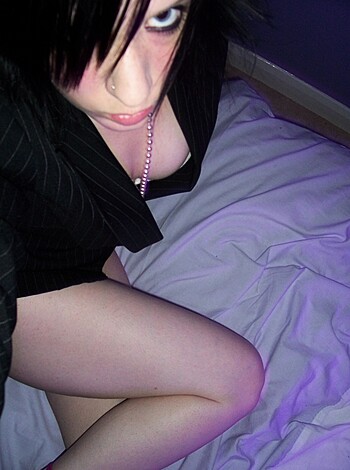 A bitch sits her cunt down on the mattress with legs spread open and fingers playing with pussy juices while talking shit about dick size to any fool who'll listen.