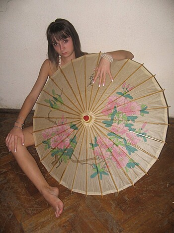 "Blowjob-loving milf with long hair sits her sexy ass on a fan, showing off her hot gams in some fancy shoes."