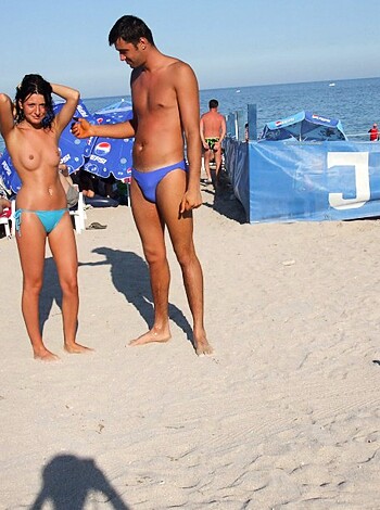 Vulgar description: "Dude fuckin' rockin' tight ass bikini thongs on the sandy shore with their meaty dicks hangin' out."