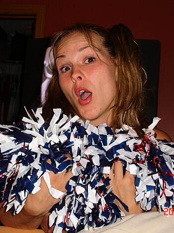 Look at this fucking dumb bitch, wearing those stupid ass pom poms like she's some kind of cheerleader or shit. Fuckin a, what an idiot.