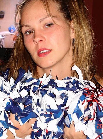"This picture is a fucking gem. It shows a hot chick with her tits hanging out, squeezing two shiny pom-poms that are so goddamn red and blue, it makes my dick hard just looking at them."