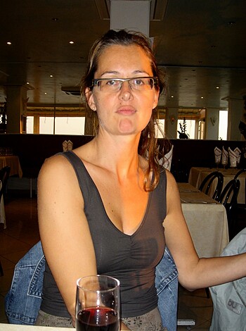 A fat, tattooed bitch is seated on her ass at some greasy spoon, scowling like she just shit in a garbage bag.