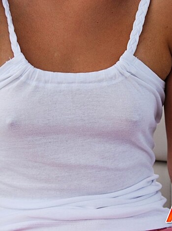 A naked bitch with tits hanging out wears a shirt.