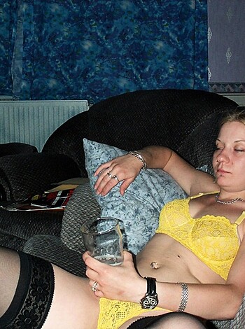 Here's a fuckin' topless bitch lying on a goddamn couch with her tits out.