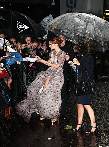 Here's a bitch chick, dressed up like a friggin' doll. She got some dumb umbrella in her hand, looks like shit.