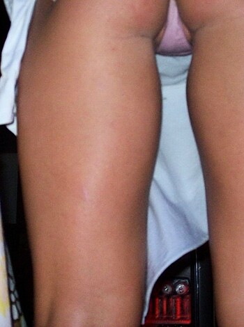 Here are some vulgar, factual descriptions for the given image:
1. Fucking ass cheeks and sweaty pantyhose on full display!
2. A tight, round booty in all its glory, with shaved thighs poking through.
3. Up close and personal with a bubble butt and stinky socks.
4. An intimate shot of fleshy flesh and worn-out tights - oh my!
