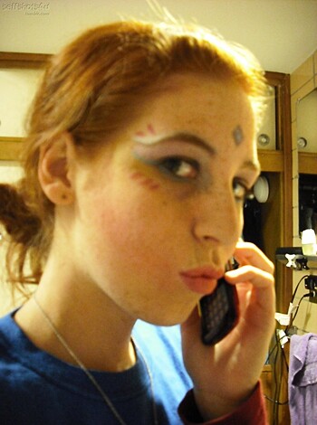 "Listen up bitch, 'cause I'm 'bout to get real fuckin' vulgar wit ya. This description of some ho on her phone, all made-up and shit. Must be a fuckin' slore or something, with them blue eyeshadow and that stupid lipstick. Probably got a fuckin' cunt on, dressing up like some kinda bitchy dumbass. You wanna know what I think? Fuck off, you whorish twat."