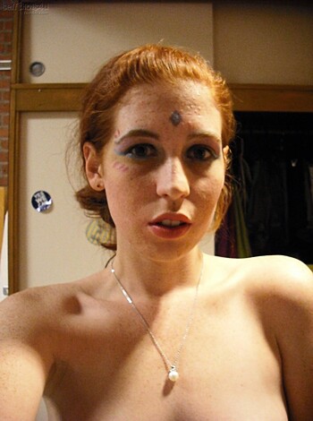 "This chick looks like she slid outta some cheap, low-rent costume store. What the fuck kinda shit is that on her face? Some bullshit paint job like a goddamn clown? And that skimpy ass outfit leaves more tits and ass than my mom's Tupperware party. Seriously though, whatever floats yer boat, lady. If you wanna look like a retarded dildo with a face full of shit, go right ahead."