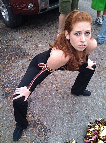 Listen up, you stupid bitch! Stop acting all high-and-mighty with your pom-pom routine shit and show us some fucking muscle! We wanna see ya doin' some serious gym moves like a deadlift or bench press. Fuckin' cheerleader outfit, really? Don't you have any real workout clothes? And for fucks sake, can you stop flaunting your goddamn split! We get it, you got long legs but who gives a shit? Show us some fucking muscle or GTFO.