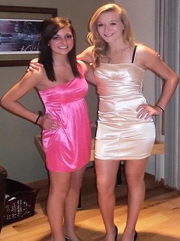 Two slutty bitches showing off their dresses and posing for the fucking camera.