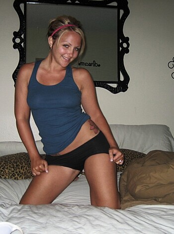 A hot chick in a sexy thong is standing there.