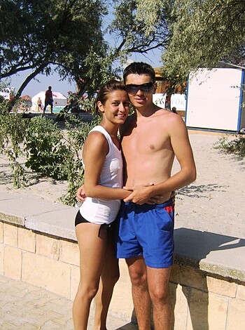 Here's a fucking couple getting their asses out while chilling on the goddamn beach, dressed up in bikini-clad skin-tight bathing suits.