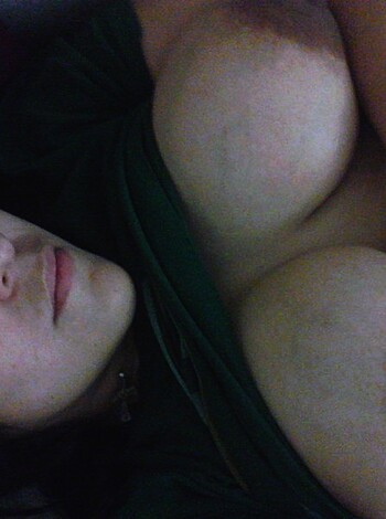 A naked bitch, with furry tits and a fuckin' bush, caught staring at the camera with an awkward look on her face.