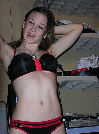 "Stripping down to her skimpy lingerie, this buxom broad flaunts her ample assets with aplomb - her massive melons and middling mound on full display."