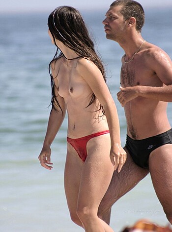 "Fuckin' hot couple strolling on the sandy shoreline with their dicks out, chillin' at the fucking beach."