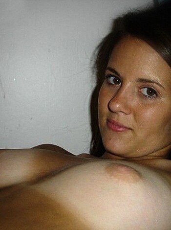 A naked chick is sprawled out on her back with her hand dangling between her legs like she's gotta take a shit or something.