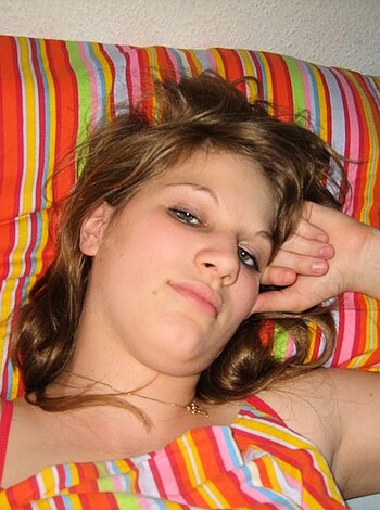 This is a picture of some bitch with her boobs all out in a fucking stripy bra, that shit looks tight as hell.
