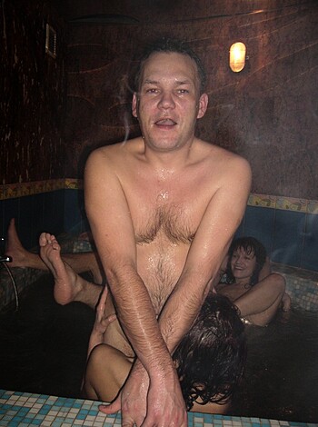 A dude with his dick hanging out is about to take a shit in a bathtub full of other fucking naked folks.