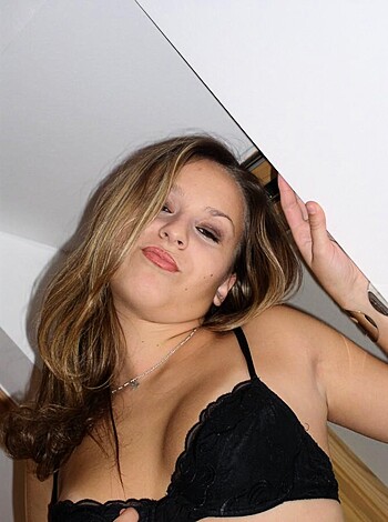 A hot babe in her underwear, striking a pose with one leg in the air and her hand on her hip, all for your viewing pleasure.
