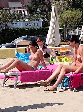 "Get an eyeful as these two fuckers go commando on the beach, letting their dicks and tits hang out for all to see."
