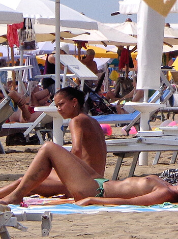 A fuckin beach filled with motherfuckers soakin up some goddamn rays under goddamn umbrellas.