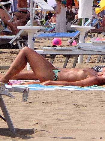 "F*ckin' hot chick in skimpy swimwear gettin' down on the beach."