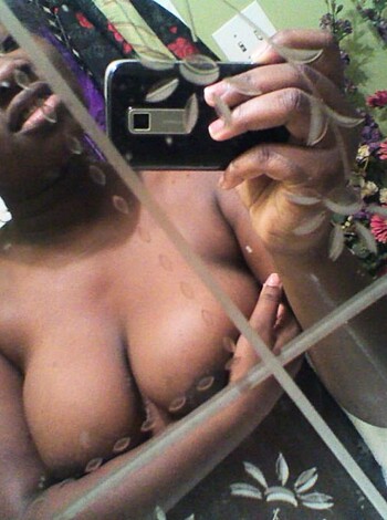 A fucking naked bitch taking a selfie while checking out her tits in the mirror.